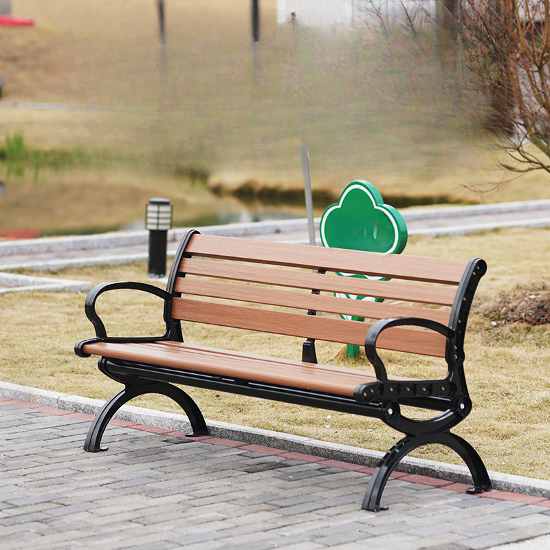 Simple Outdoor Bench in Tan with Back, Metal Frame, and Curved Arm