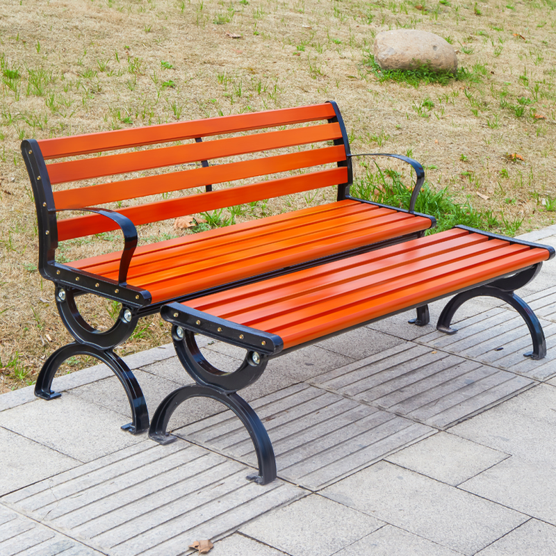Simple Outdoor Bench with Tan Seating, Back, Metal Frame, and Curved Arm